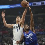 
              Dallas Mavericks center Dwight Powell, left and Los Angeles Clippers forward Kawhi Leonard reach for a rebound during the first half of an NBA basketball game Tuesday, Jan. 10, 2023, in Los Angeles. (AP Photo/Mark J. Terrill)
            