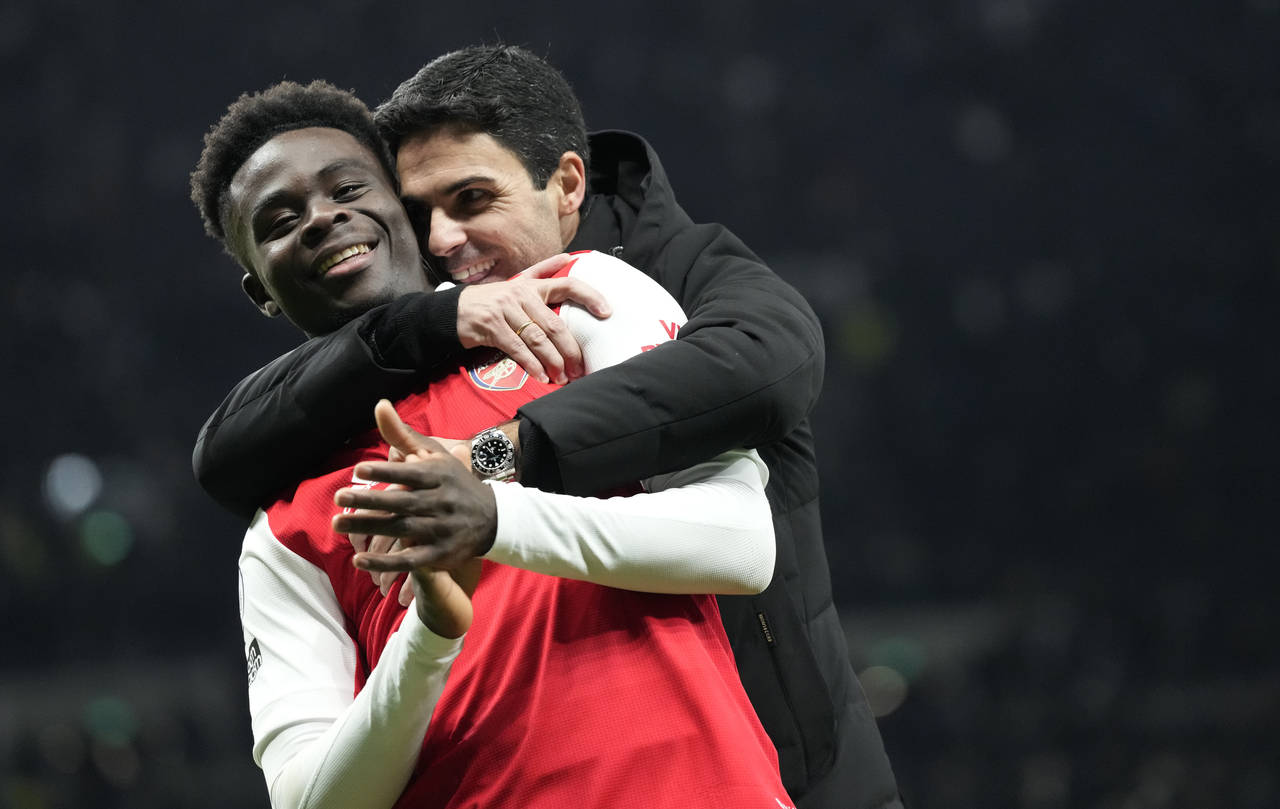 Arsenal's Bukayo Saka and Arsenal's manager Mikel Arteta celebrate their victory at the English Pre...