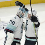 
              Seattle Kraken goaltender Martin Jones (30) celebrates with teammate Daniel Sprong (91) after shutting out the Montreal Canadiens in NHL hockey game action Monday, Jan. 9, 2023, in Montreal. (Ryan Remiorz/The Canadian Press via AP)
            