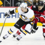 
              Pittsburgh Penguins' Sidney Crosby (87) drives past New Jersey Devils' Ryan Graves (33) during the first period of an NHL hockey game, Sunday, Jan. 22, 2023, in Newark, N.J. (AP Photo/Frank Franklin II)
            