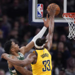 
              Milwaukee Bucks' Giannis Antetokounmpo (34) puts up a shot against Indiana Pacers' Myles Turner (33) during the first half of an NBA basketball game, Friday, Jan. 27, 2023, in Indianapolis. (AP Photo/Darron Cummings)
            