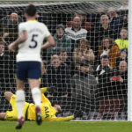 
              Tottenham's goalkeeper Hugo Lloris dives but fails to save the goal from Arsenal's Martin Odegaard during the English Premier League soccer match between Tottenham Hotspur and Arsenal at the Tottenham Hotspur Stadium in London, England, Sunday, Jan. 15, 2023. (AP Photo/Frank Augstein)
            