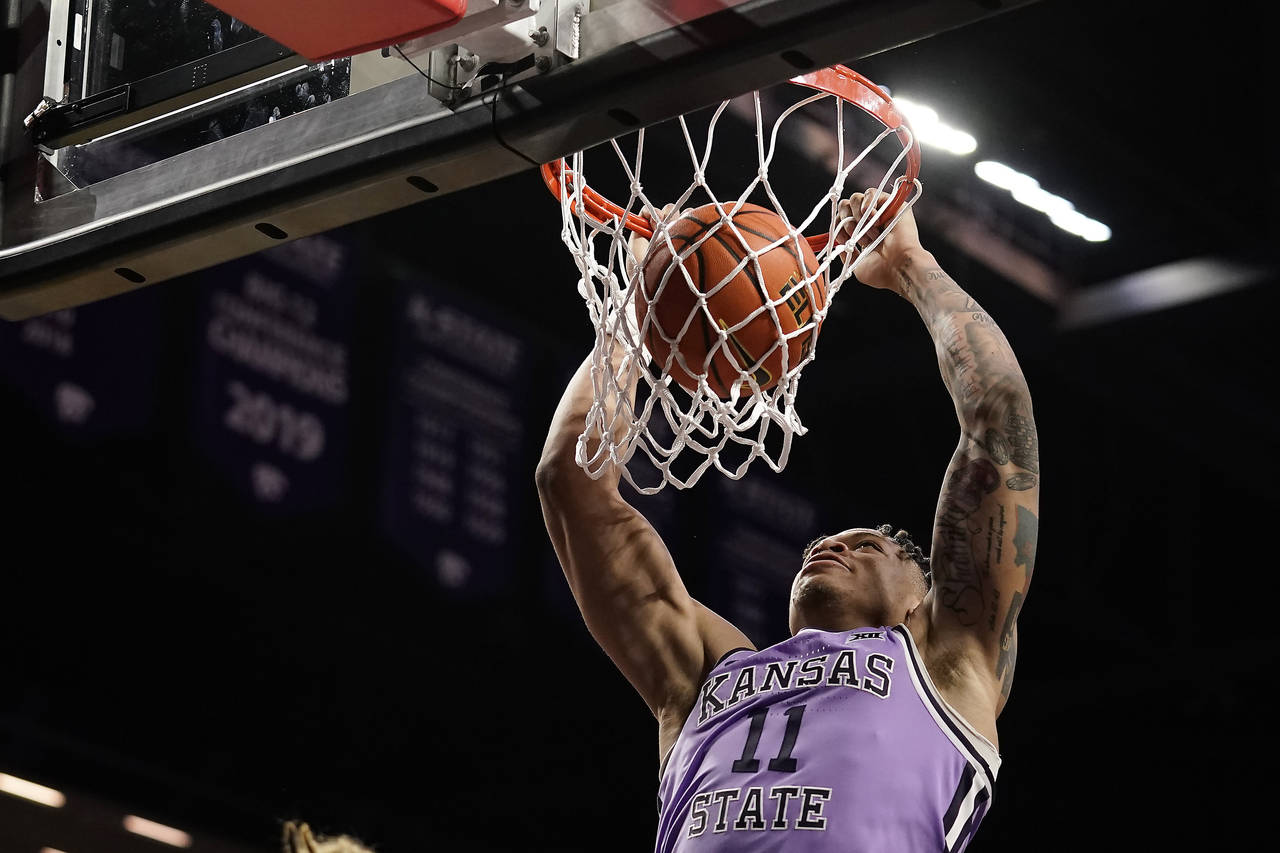 Kansas State forward Keyontae Johnson dunks the ball during the second half of an NCAA college bask...