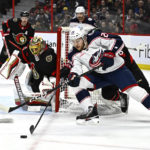
              Columbus Blue Jackets right wing Mathieu Olivier (24) tries to wrap the puck around the net of Ottawa Senators goaltender Anton Forsberg (31) during the first period of an NHL hockey game, Tuesday, Jan. 3, 2023 in Ottawa, Ontario. (Justin Tang/The Canadian Press via AP)
            