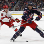 
              Columbus Blue Jackets forward Patrik Laine, right, passes the puck in front of Carolina Hurricanes forward Teuvo Teravainen during the second period of an NHL hockey game in Columbus, Ohio, Thursday, Jan. 12, 2023. (AP Photo/Paul Vernon)
            