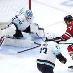 
              Seattle Kraken goaltender Martin Jones deflects the puck away from Chicago Blackhawks' Sam Lafferty during the first period of an NHL hockey game Saturday, Jan. 14, 2023, in Chicago. (AP Photo/Charles Rex Arbogast)
            