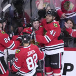 
              Chicago Blackhawks' Isaak Phillips (41) celebrates his first career NHL goal with Sam Lafferty (24) Caleb Jones (82) and Tyler Johnson during the second period of a hockey game against the Seattle Kraken, Saturday, Jan. 14, 2023, in Chicago. (AP Photo/Charles Rex Arbogast)
            