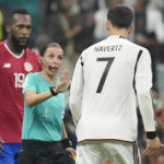 
              FILE - Referee Stephanie Frappart talks with Germany's Kai Havertz during the World Cup group E soccer match between Costa Rica and Germany at the Al Bayt Stadium in Al Khor, Qatar, on Dec.1, 2022. The six female match officials who worked at the men’s World Cup in Qatar including history maker Stephanie Frappart were also selected Monday Jan. 9, 2023 by FIFA for the 2023 Women’s World Cup, which will have 13 men in the video review team. (AP Photo/Moises Castillo, File)
            