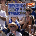 
              A supporter of Stefanos Tsitsipas of Greece holds up a sign during his semifinal against Karen Khachanov at the Australian Open tennis championship in Melbourne, Australia, Friday, Jan. 27, 2023. (AP Photo/Dita Alangkara)
            