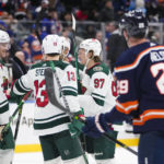 
              Minnesota Wild's Kirill Kaprizov (97) celebrates with teammates after scoring a goal against the New York Islanders during the third period of an NHL hockey game Thursday, Jan. 12, 2023, in Elmont, N.Y. The Wild won 3-1. (AP Photo/Frank Franklin II)
            