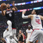 
              Houston Rockets guard Eric Gordon (10) scores past Los Angeles Clippers center Ivica Zubac (40) during the first half of an NBA basketball game Sunday, Jan. 15, 2023, in Los Angeles. (AP Photo/Marcio Jose Sanchez)
            