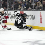 
              Los Angeles Kings center Phillip Danault, right, falls while under pressure from New Jersey Devils defenseman Ryan Graves during the second period of an NHL hockey game Saturday, Jan. 14, 2023, in Los Angeles. (AP Photo/Mark J. Terrill)
            