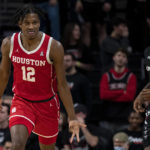 
              Houston Cougars guard Tramon Mark (12) celebrates after hitting a 3-point shot in the second half of an NCAA college basketball game against Houston Cougars on Sunday, Jan 8, 2023, in Cincinnati. (Albert Cesare/The Cincinnati Enquirer via AP)
            