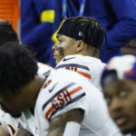 
              Chicago Bears quarterback Justin Fields, center, sits on the bench during the second half of an NFL football game against the Detroit Lions, Sunday, Jan. 1, 2023, in Detroit. (AP Photo/Duane Burleson)
            