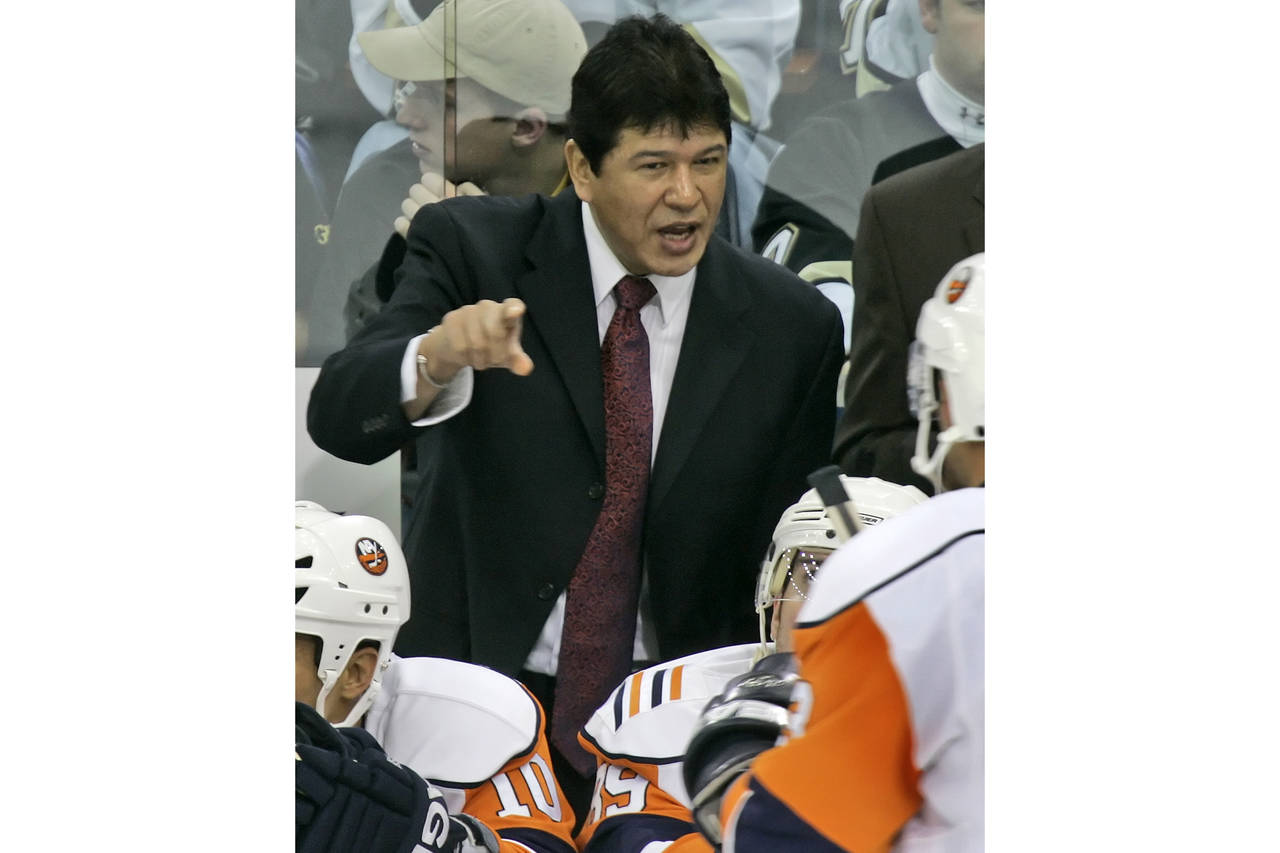FILE - New York Islanders coach Ted Nolan talks with his players during a timeout late in the third...