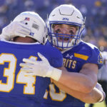 
              South Dakota State fullback Michael Morgan (34) is hugged by teammate Jaxon Janke (10) after scoring a touchdown during the first half of the FCS Championship NCAA college football game against North Dakota, Sunday, Jan. 8, 2023, in Frisco, Texas. (AP Photo/LM Otero)
            