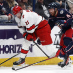 
              Carolina Hurricanes forward Stefan Noesen, left, passes in front of Columbus Blue Jackets defenseman Vladislav Gavrikov, center, and forward Kent Johnson during the first period of an NHL hockey game in Columbus, Ohio, Thursday, Jan. 12, 2023. (AP Photo/Paul Vernon)
            