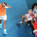 
              Rafael Nadal, left, of Spain walks past opponent Mackenzie McDonald of the U.S., during a break in their second round match at the Australian Open tennis championship in Melbourne, Australia, Wednesday, Jan. 18, 2023. (AP Photo/Dita Alangkara)
            
