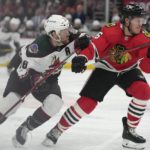 
              Arizona Coyotes right wing Christian Fischer (36) and Chicago Blackhawks defenseman Jake McCabe (6) struggle together as they go after the puck during the first period of an NHL hockey game Friday, Jan. 6, 2023, in Chicago. (AP Photo/Erin Hooley)
            