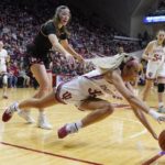 
              Indiana's Sydney Parrish (33) dives for a loose ball as Nebraska's Isabelle Bourne (34) watches during the first half of an NCAA college basketball game, Sunday, Jan. 1, 2023, in Bloomington, Ind. (AP Photo/Darron Cummings)
            