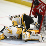 
              Washington Capitals defenseman Martin Fehervary (42) crashes into the Pittsburgh Penguins net along with Penguins center Sidney Crosby (87) during the third period of an NHL hockey game, Thursday, Jan. 26, 2023, in Washington. Penguins goaltender Casey DeSmith (1) lies on the ice. (AP Photo/Nick Wass)
            