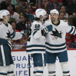 
              San Jose Sharks' Jonah Gadjovich (42) celebrates with teammates Tomas Hertl and Oskar Lindblom (23) after scoring during the second period of an NHL hockey game against the Chicago Blackhawks, Sunday, Jan. 1, 2023, in Chicago. (AP Photo/Paul Beaty)
            