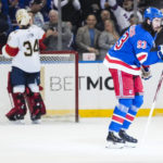 
              New York Rangers' Mika Zibanejad (93) gestures to his bench as he skates past Florida Panthers goaltender Alex Lyon (34) after scoring a goal during the first period of an NHL hockey game Monday, Jan. 23, 2023, in New York. (AP Photo/Frank Franklin II)
            