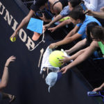 
              Tommy Paul of the U.S. signs autographs after defeating compatriot Ben Shelton in their quarterfinal match at the Australian Open tennis championship in Melbourne, Australia, Wednesday, Jan. 25, 2023. (AP Photo/Ng Han Guan)
            