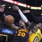
              Atlanta Hawks' John Collins (20) and Indiana Pacers' Bennedict Mathurin (00) compete for a rebound during the first half of an NBA basketball game Friday, Jan. 13, 2023, in Indianapolis. (AP Photo/Darron Cummings)
            
