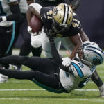 
              New Orleans Saints running back Alvin Kamara is tackled by Carolina Panthers safety Xavier Woods during the first half an NFL football game between the Carolina Panthers and the New Orleans Saints in New Orleans, Sunday, Jan. 8, 2023. (AP Photo/Gerald Herbert)
            
