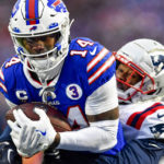 
              Buffalo Bills wide receiver Stefon Diggs (14) runs in a touchdown against New England Patriots cornerback Jonathan Jones (31) during the second half of an NFL football game, Sunday, Jan. 8, 2023, in Orchard Park. (AP Photo/Adrian Kraus)
            