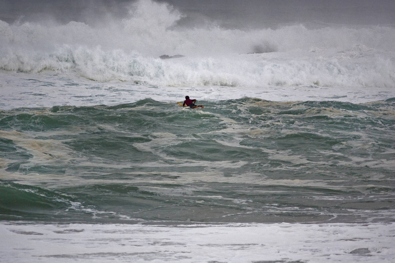 FILE - Ramon Navarro, of Chile, paddles out to ride in the Eddie Aikau big-wave surfing contest in ...