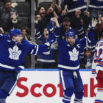 
              Toronto Maple Leafs defenseman Timothy Liljegren, left, celebrates his goal against the New York Rangers with forward John Tavares (91) during the third period of an NHL hockey game Wednesday, Jan. 25, 2023, in Toronto. (Nathan Denette/The Canadian Press via AP)
            