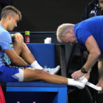 
              Enzo Couacaud of France has his ankle taped during his second round match against Novak Djokovic of Serbia at the Australian Open tennis championship in Melbourne, Australia, Thursday, Jan. 19, 2023. (AP Photo/Dita Alangkara)
            