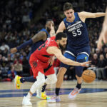 
              Toronto Raptors guard Fred VanVleet (23) works towards the basket while defended by Minnesota Timberwolves center Luka Garza (55) during the second half of an NBA basketball game, Thursday, Jan. 19, 2023, in Minneapolis. (AP Photo/Abbie Parr)
            