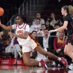 
              Southern California guard Okako Adika, left, as she passes the ball while under pressure from Stanford forward Brooke Demetre during the first half of an NCAA college basketball game Sunday, Jan. 15, 2023, in Los Angeles. (AP Photo/Mark J. Terrill)
            
