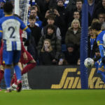 
              Brighton's Kaoru Mitoma, right, scores his side's second goal during the FA Cup 4th round soccer match between Brighton and Hove Albion and Liverpool at the Falmer Stadium in Brighton, England, Sunday, Jan. 29, 2023. (AP Photo/Alastair Grant)
            
