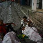 
              Soccer fans sleep outside the Vila Belmiro stadium waiting for the doors to open for the wake of the late Brazilian soccer star Pele, in Santos, Brazil Monday, Jan. 2, 2023. (AP Photo/Matias Delacroix)
            