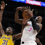 
              Miami Heat center Bam Adebayo, right, grabs a rebound away from Los Angeles Lakers center Thomas Bryant during the second half of an NBA basketball game Wednesday, Jan. 4, 2023, in Los Angeles. (AP Photo/Mark J. Terrill)
            
