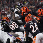 
              Cincinnati Bengals linebacker Logan Wilson (55) knocks the ball away from Baltimore Ravens quarterback Tyler Huntley causing a fumble in the second half of an NFL wild-card playoff football game in Cincinnati, Sunday, Jan. 15, 2023. Bengals defensive end Sam Hubbard recovered the fumble and ran it back 98-yards for a touchdown. (AP Photo/Jeff Dean)
            