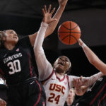 
              Stanford guard Haley Jones (30) and forward Brooke Demetre (21) grapple for a loose ball with Southern California guard Okako Adika (24) during the first half of an NCAA college basketball game Sunday, Jan. 15, 2023, in Los Angeles. (AP Photo/Mark J. Terrill)
            