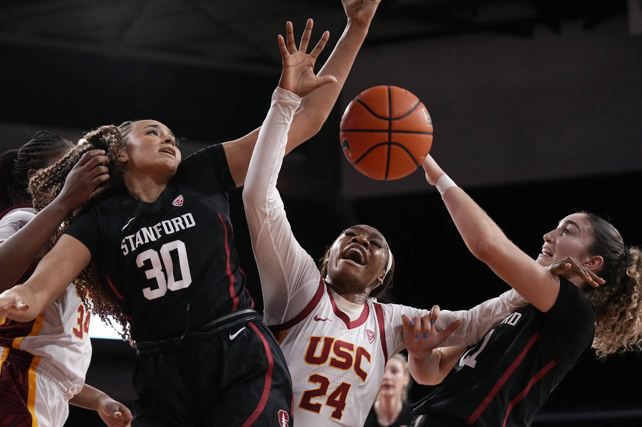 Stanford guard Haley Jones (30) and forward Brooke Demetre (21) grapple for a loose ball with South...