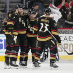 
              Vegas Golden Knights celebrate after center Nicolas Roy, second from left, scored against the Washington Capitals during the first period of an NHL hockey game Saturday, Jan. 21, 2023, in Las Vegas. (AP Photo/John Locher)
            