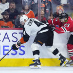 
              Philadelphia Flyers' Nicolas Deslauriers, left, tries to keep away from Chicago Blackhawks' Philipp Kurashev during the third period of an NHL hockey game, Thursday, Jan. 19, 2023, in Philadelphia. (AP Photo/Matt Slocum)
            