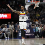 
              Minnesota Timberwolves guard D'Angelo Russell (0) celebrates after a three-point basket by forward Nathan Knight (13) during the first half of an NBA basketball game against the Memphis Grizzlies, Friday, Jan. 27, 2023, in Minneapolis. (AP Photo/Abbie Parr)
            