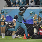 
              Jacksonville Jaguars linebacker Josh Allen (41) returns a fumble for a touchdown in the second half of an NFL football game against the Tennessee Titans, Saturday, Jan. 7, 2023, in Jacksonville, Fla. (AP Photo/Phelan M. Ebenhack)
            