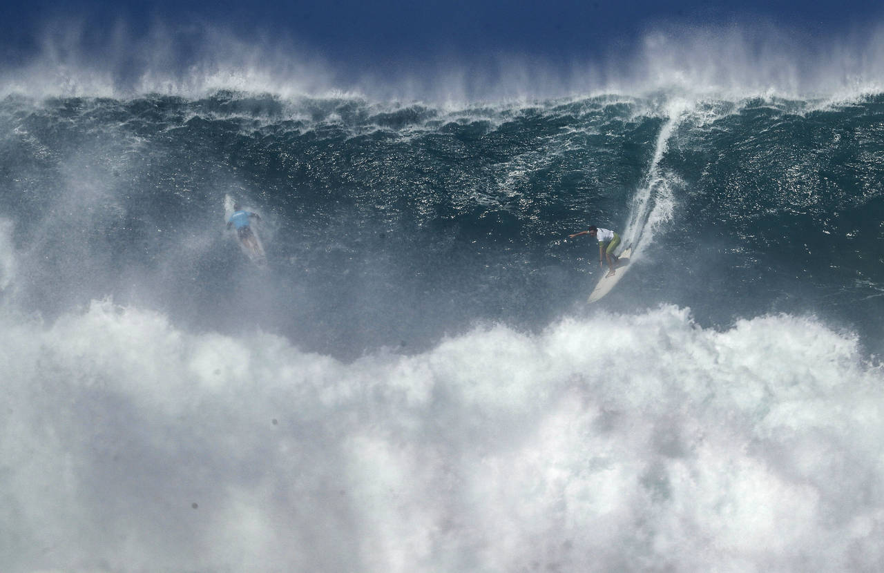 Luke Shepardson rides a wave during The Eddie Aikau Big Wave Invitational at Waimea Bay on Sunday, ...