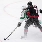 
              Dallas Stars' Ty Dellandrea (10) loses his balance on an attack after being hit by Carolina Hurricanes' Brady Skjei (76) during the first period of an NHL hockey game Wednesday, Jan. 25, 2023, in Dallas. (AP Photo/Tony Gutierrez)
            