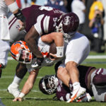 
              Illinois quarterback Tommy DeVito (3) gets sacked by Mississippi State defensive tackle Jaden Crumedy (94) during the first half of the ReliaQuest Bowl NCAA college football game Monday, Jan. 2, 2023, in Tampa, Fla. (AP Photo/Chris O'Meara)
            