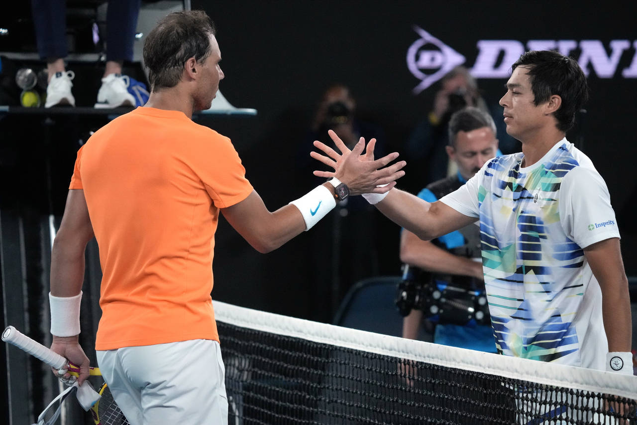 Rafael Nadal, left, of Spain congratulates Mackenzie McDonald of the U.S., following their second r...